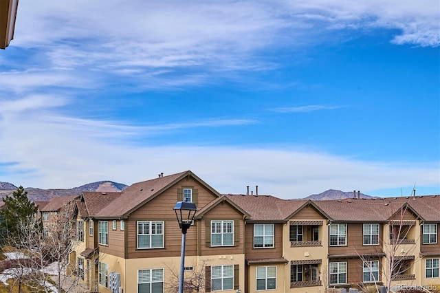 view of front of home with a mountain view and stucco siding