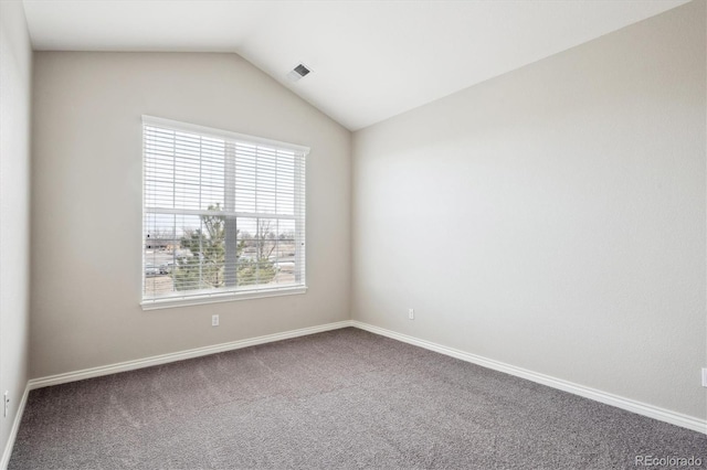 carpeted spare room with lofted ceiling, visible vents, and baseboards