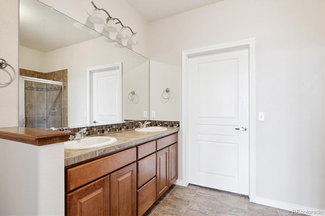 bathroom featuring vanity, an enclosed shower, and decorative backsplash