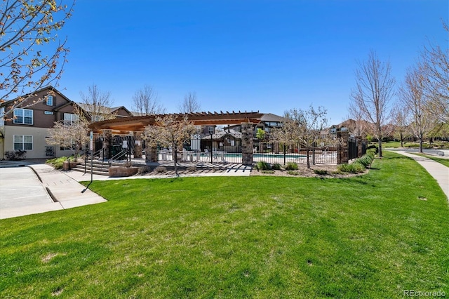 exterior space featuring a pergola, a swimming pool, and a lawn