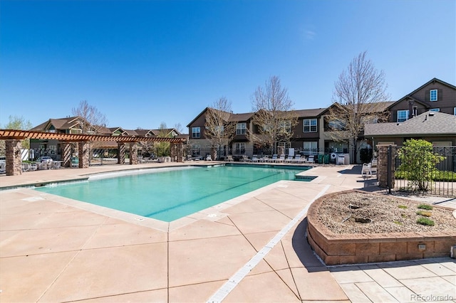 pool featuring a residential view, fence, a pergola, and a patio