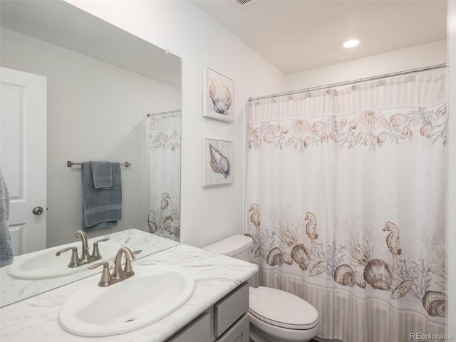 bathroom with vanity, toilet, and a shower with shower curtain