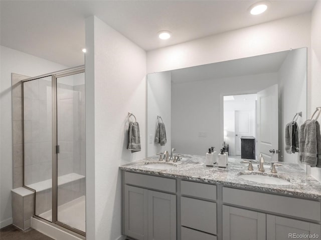 bathroom with vanity and a shower with shower door