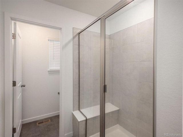 bathroom featuring a shower with door