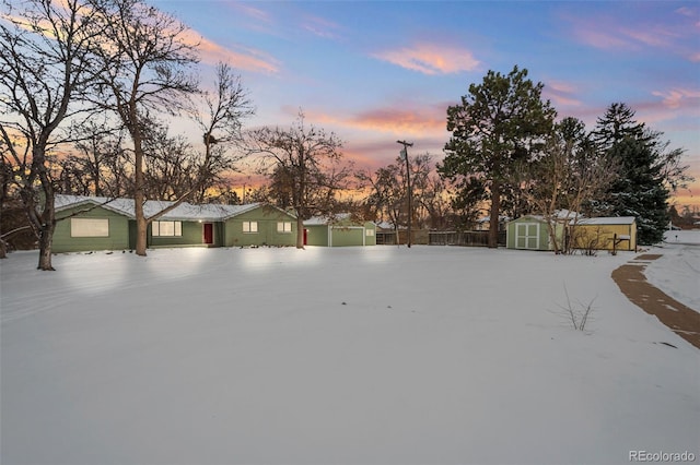 yard at dusk featuring a shed