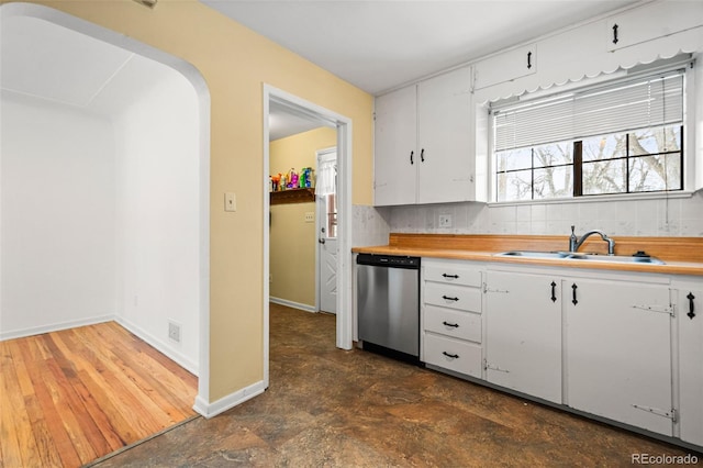 kitchen featuring sink, white cabinets, dishwasher, and tasteful backsplash