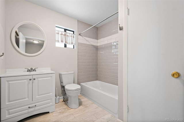 full bathroom featuring vanity, toilet, hardwood / wood-style floors, and tiled shower / bath combo