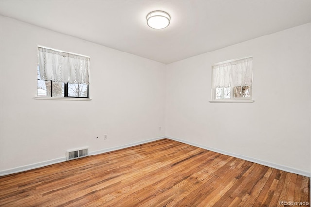 spare room with light hardwood / wood-style flooring