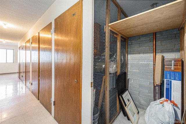 corridor featuring a textured ceiling