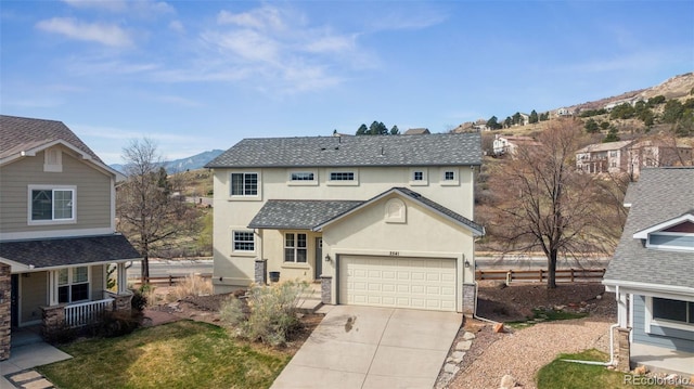 2541 Hot Springs Ct, Colorado Springs, CO 80919 - traditional-style home with a mountain view, driveway, a porch, a garage, and stucco siding