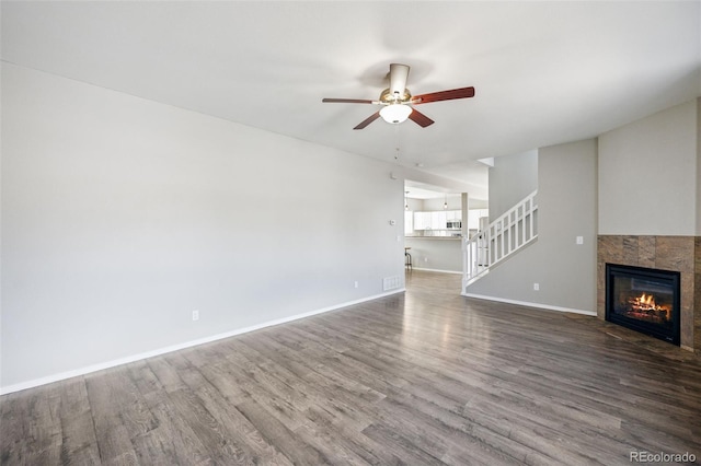 2541 Hot Springs Ct, Colorado Springs, CO 80919 - unfurnished living room featuring stairway, wood finished floors, a ceiling fan, baseboards, and a fireplace