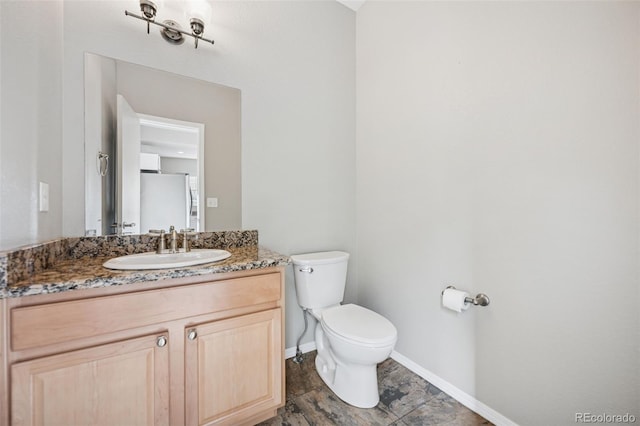 2541 Hot Springs Ct, Colorado Springs, CO 80919 - half bathroom with vanity, toilet, and baseboards