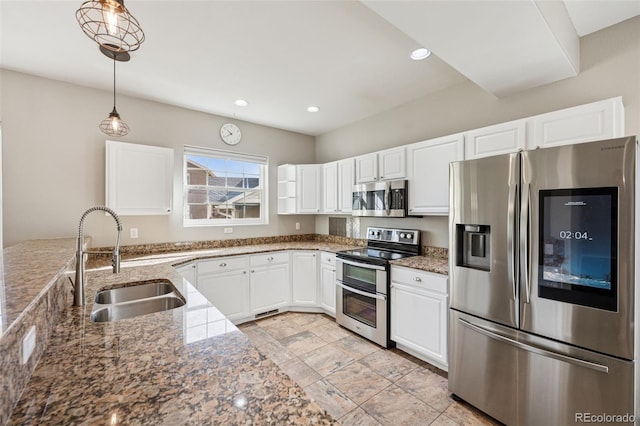 2541 Hot Springs Ct, Colorado Springs, CO 80919 - kitchen with a sink, pendant lighting, white cabinetry, stone counters, and appliances with stainless steel finishes