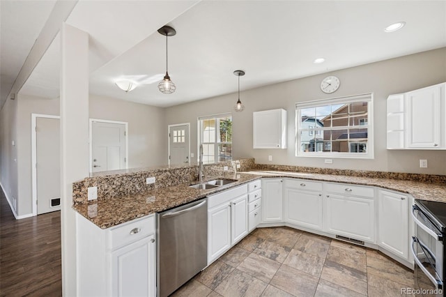 2541 Hot Springs Ct, Colorado Springs, CO 80919 - kitchen with a sink, recessed lighting, white cabinetry, pendant lighting, and appliances with stainless steel finishes