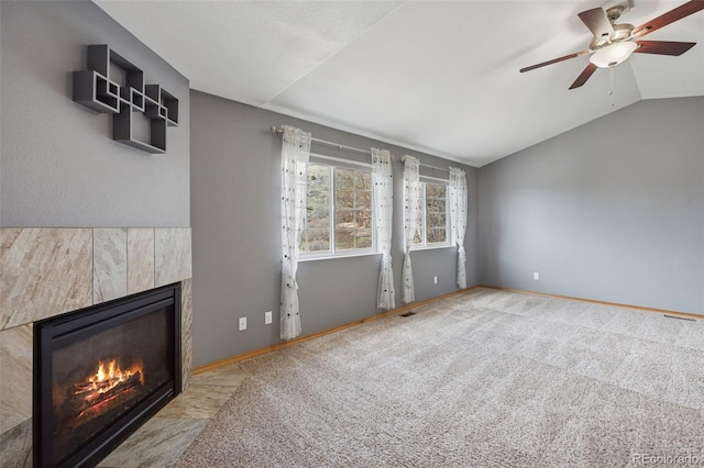 2541 Hot Springs Ct, Colorado Springs, CO 80919 - unfurnished living room featuring lofted ceiling, a tile fireplace, carpet flooring, and ceiling fan
