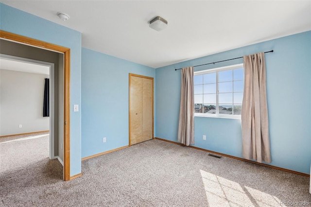 2541 Hot Springs Ct, Colorado Springs, CO 80919 - unfurnished bedroom with baseboards, a closet, visible vents, and carpet