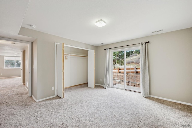2541 Hot Springs Ct, Colorado Springs, CO 80919 - unfurnished bedroom with a closet, baseboards, carpet flooring, access to exterior, and visible vents