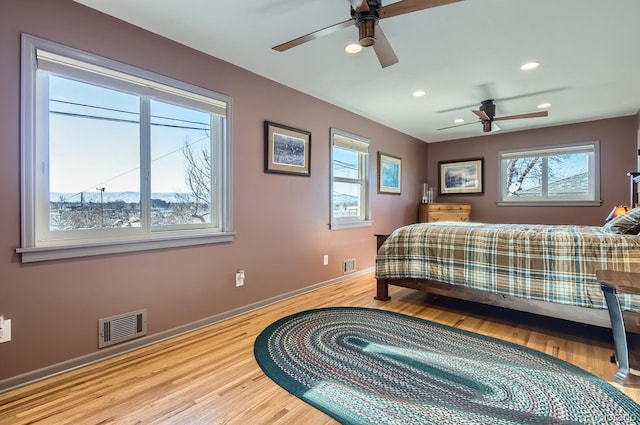 bedroom with ceiling fan and light hardwood / wood-style floors