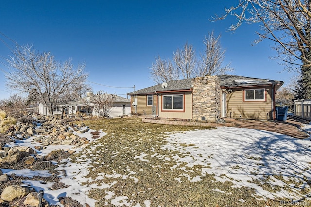 snow covered property with a patio area and a lawn