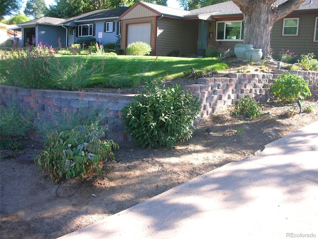 view of front of home with a garage and a front yard