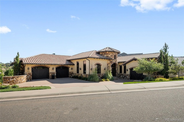 mediterranean / spanish-style home with a garage