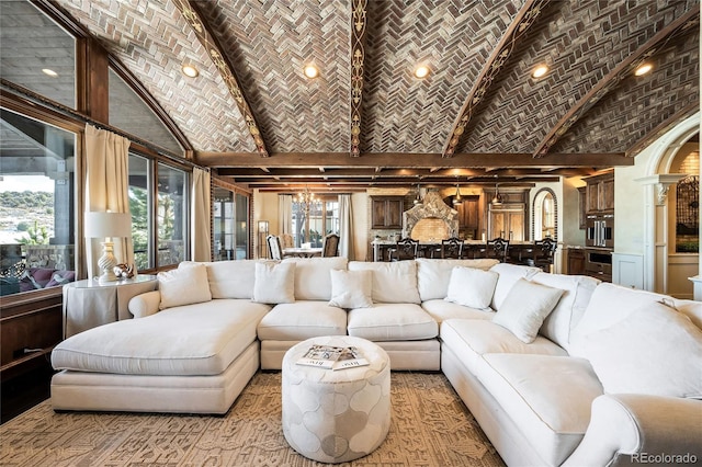 living room with an inviting chandelier, brick ceiling, and a high ceiling