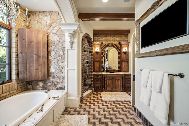 bathroom featuring vanity, decorative columns, shower with separate bathtub, and beamed ceiling