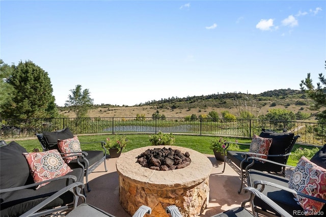 view of patio / terrace with a rural view and a fire pit