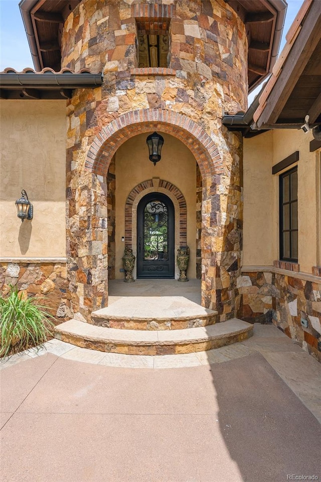 7188 Raphael Ln, Littleton, CO 80125 - property entrance with stone siding and stucco siding