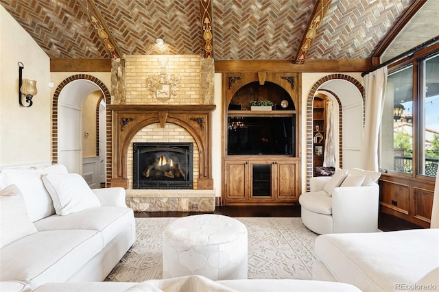 7188 Raphael Ln, Littleton, CO 80125 - living room featuring brick ceiling, built in shelves, a brick fireplace, and lofted ceiling