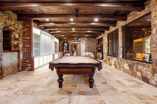 7188 Raphael Ln, Littleton, CO 80125 - recreation room with arched walkways, stone tile flooring, pool table, and built in shelves