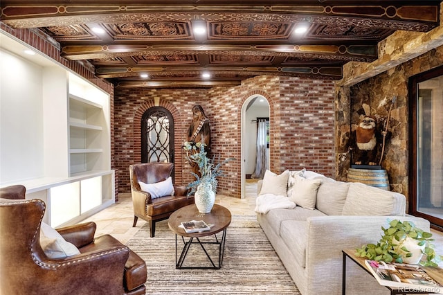 7188 Raphael Ln, Littleton, CO 80125 - living room with arched walkways, brick wall, and built in features