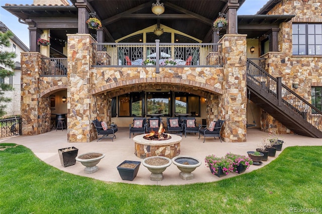 7188 Raphael Ln, Littleton, CO 80125 - back of house with an outdoor fire pit, a patio, stairs, a balcony, and a fireplace