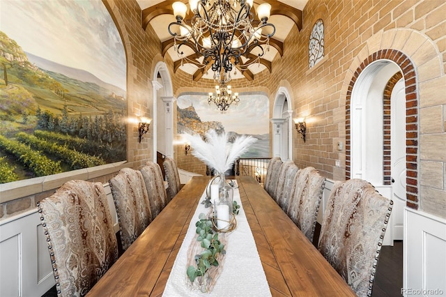 7188 Raphael Ln, Littleton, CO 80125 - dining space featuring a chandelier, arched walkways, and brick wall