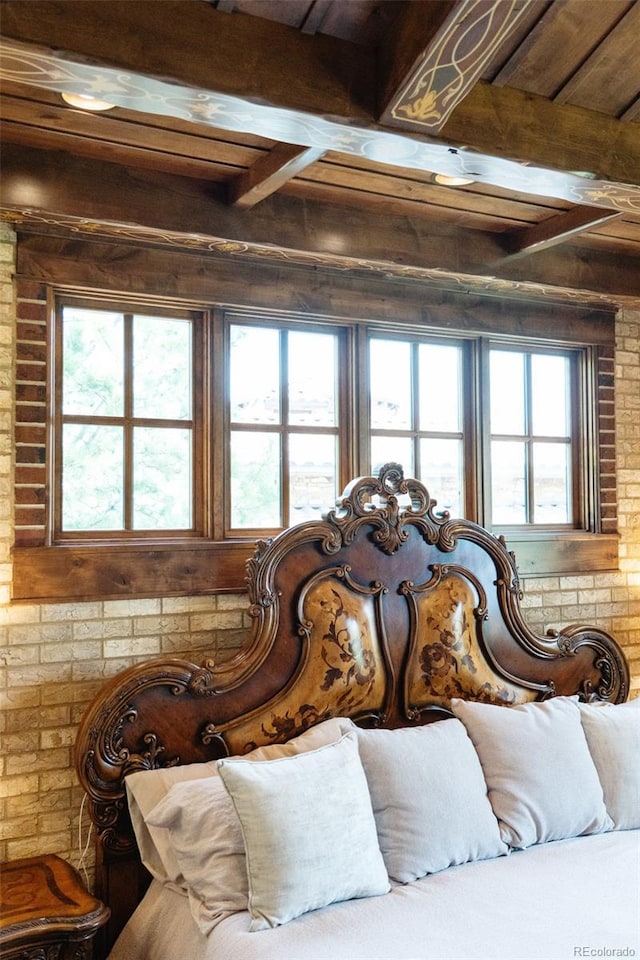 7188 Raphael Ln, Littleton, CO 80125 - bedroom with beam ceiling and brick wall