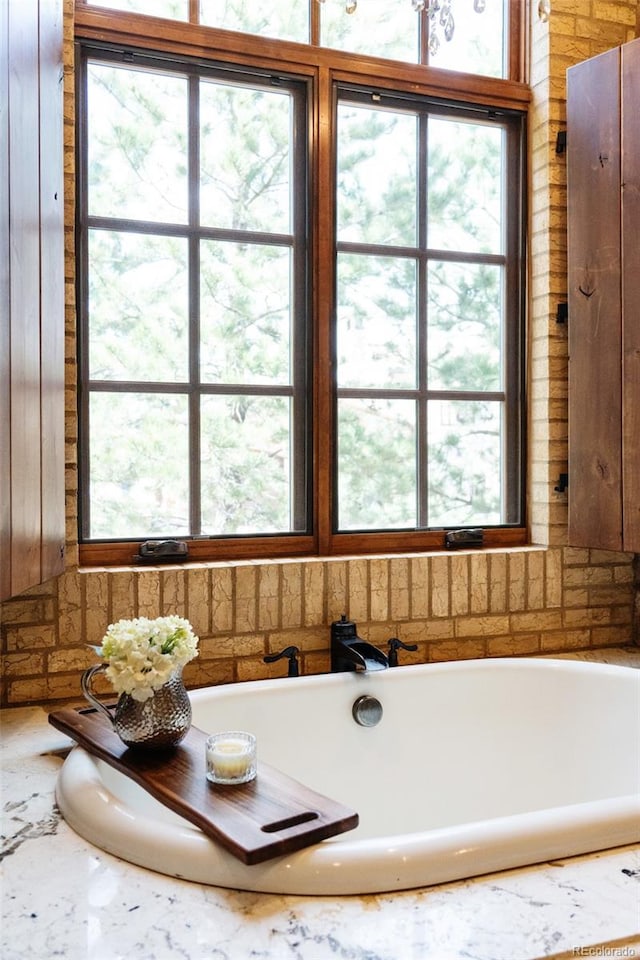 7188 Raphael Ln, Littleton, CO 80125 - bathroom with a tub to relax in and healthy amount of natural light
