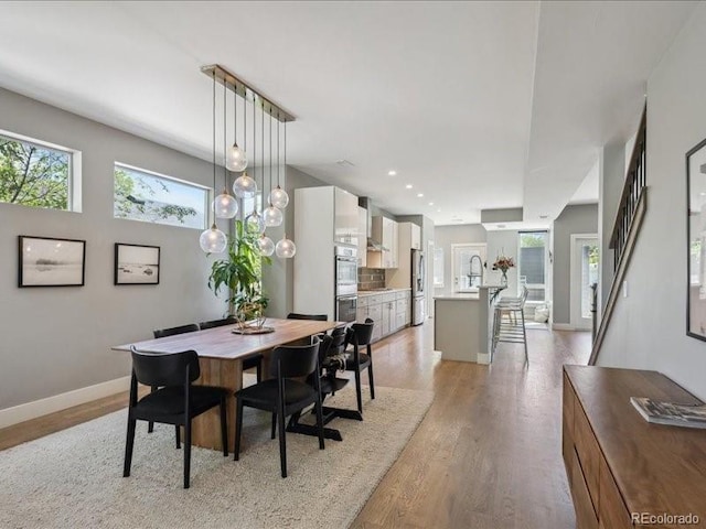 2508 S Pennsylvania St, Denver, CO 80210 - dining space with plenty of natural light, light wood-style floors, baseboards, and recessed lighting
