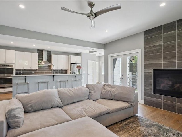 2508 S Pennsylvania St, Denver, CO 80210 - living area featuring recessed lighting, an accent wall, wood finished floors, and a ceiling fan