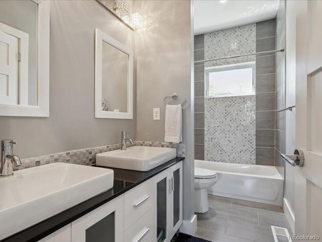 2508 S Pennsylvania St, Denver, CO 80210 - full bath with toilet, washtub / shower combination, tile patterned floors, and double vanity