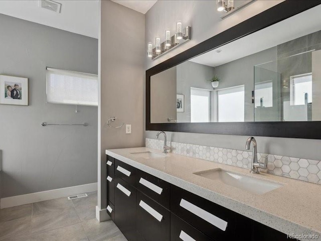2508 S Pennsylvania St, Denver, CO 80210 - bathroom featuring tile patterned flooring, double vanity, and baseboards