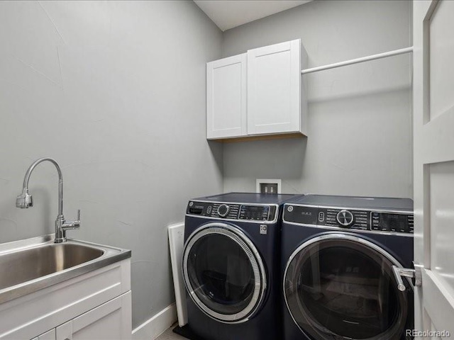 2508 S Pennsylvania St, Denver, CO 80210 - laundry area with washing machine and clothes dryer, cabinet space, and baseboards