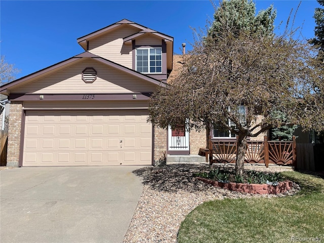 view of front of house featuring brick siding, a garage, and concrete driveway