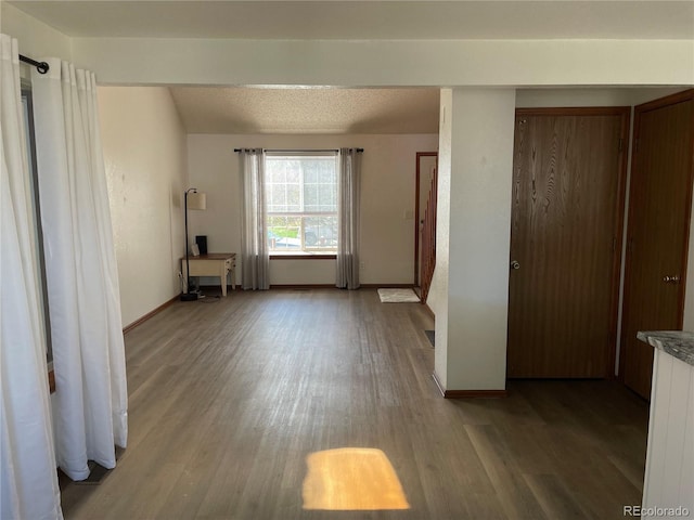unfurnished bedroom featuring wood finished floors and baseboards