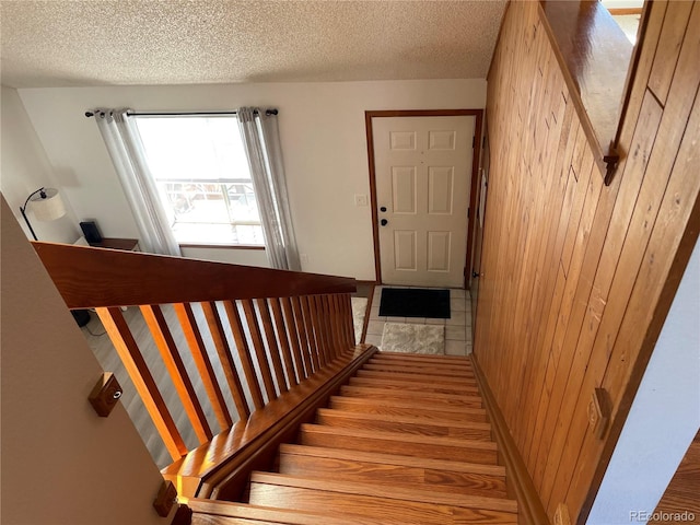 stairway with a textured ceiling