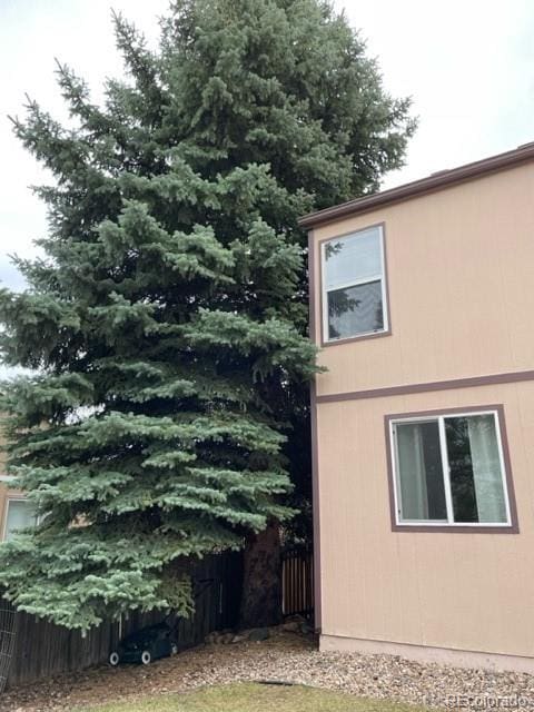view of side of home with fence