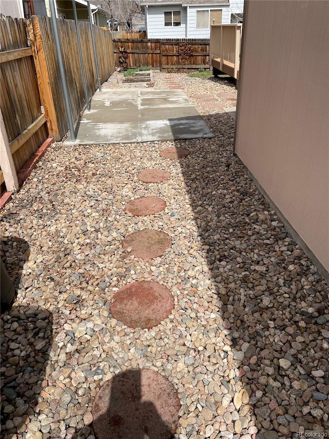 view of yard featuring a patio area and a fenced backyard