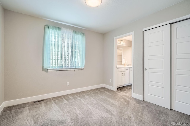 8917 Yates Dr, Westminster, CO 80031 - unfurnished bedroom featuring light colored carpet, a closet, and ensuite bathroom