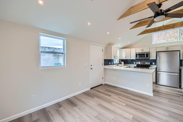 kitchen featuring lofted ceiling with beams, appliances with stainless steel finishes, a peninsula, light countertops, and backsplash