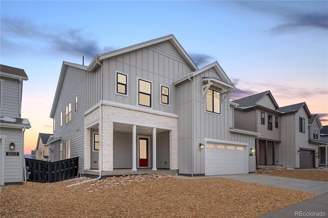 8850 Moonshimmer Trl, Littleton, CO 80125 - modern farmhouse featuring board and batten siding, covered porch, a garage, and driveway