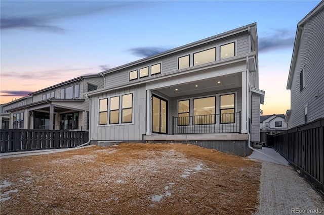 8850 Moonshimmer Trl, Littleton, CO 80125 - rear view of property featuring board and batten siding and a porch